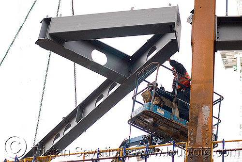 steel frame building construction - steel beams - the walbrook (london), aerial lift, boom lift, building construction, cherry picker, construction worker, crane, high-visibility jacket, high-visibility vest, london, reflective jacket, reflective vest, safety harness, safety helmet, steel beams, steel frame