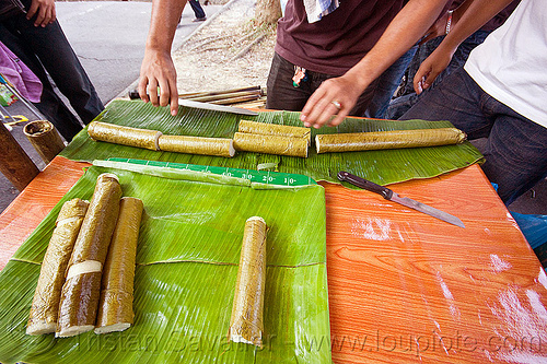 sticky rice in banana leaves cooked in bamboo, bamboo, banana leaves, borneo, cooked, cutting, food market, knife, malaysia, miri, ramadan market, sticky rice, street food, street market, street seller
