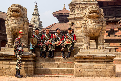 stone lions and nepali army soldiers on steps - bhaktapur durbar square (nepal), bhaktapur, durbar square, fatigues, gorkhas, guards, gurkha army, gurkha regiment, gurkhas, hat, hindu temple, hinduism, men, military, nepalese army, red stripe, sculptures, soldiers, stairs, statue, steps, stone lions, uniform