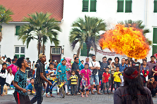 street circus performers breathing fire (jakarta), crowd, eid ul-fitr, fatahillah square, fire breather, fire breathing, fire performer, jakarta, palm trees, spectators, spitting fire, street performers, taman fatahillah