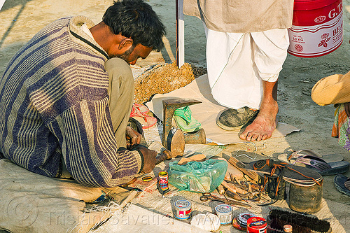 street shoemaker repairing a shoe (india), fixing, foot, hindu pilgrimage, hinduism, kumbh mela, man, repairing, shoe, shoemaker, stall, street market, street seller, street vendor, working