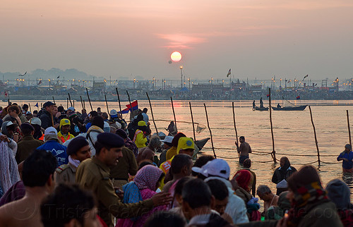 sunrise over the ganges river at sangam - kumbh mela 2013 (india), bathing pilgrims, crowd, dawn, fence, ganga, ganges river, hindu pilgrimage, hinduism, holy bath, holy dip, kumbh mela, nadi bath, paush purnima, ritual bath, river bathing, river boats, triveni sangam