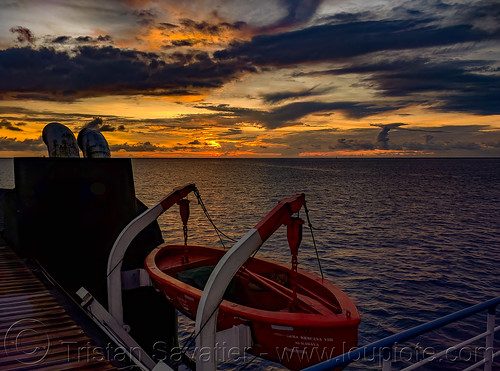 sunset over the sea - ferry lifeboat, clouds, deck, exterior, ferry, ferryboat, funnel, horizon, lifeboat, ocean, sea, sunset sky