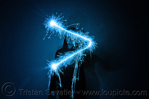 superior sign - light painting with a blue sparkler, blue, dark, greater than, icon, light drawing, light painting, sarah, silhouette, sparklers, sparkles, superior sign, symbol