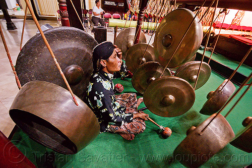 suspended bossed gongs, bossed gongs, gamelan, gong ageng, gong group, hanging gongs, man, music, musical, nipple gongs, percussion, player, ropes, sitting, suspended gongs