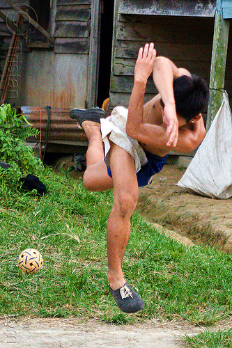 takraw player in twisted position (borneo), ball game, borneo, gunung mulu national park, kick volleyball, malaysia, man, panan, penan people, player, playing, rattan ball, sepak raga, sepak takraw, sport