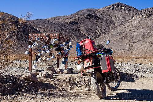 teakettle junction on the road to the racetrack (death valley), death valley, dirt road, dual-sport, fuel, gas can, gasoline, jerrycan, kawasaki, klr 650, motorcycle touring, mountains, pannier case, petrol, plastic can, rack, road sign, teakettle junction, teakettles, unpaved