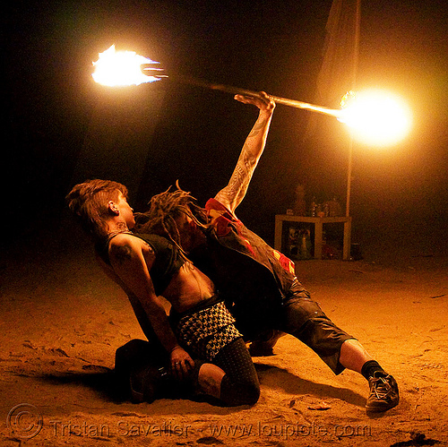 the fire of love - leah and ro spinning fire staff (san francisco) - fire dancer, bending backward, fire dancer, fire dancing, fire performer, fire spinning, fire staffs, fire staves, leah, love, man, night, spinning fire, tattooed, tattoos, woman