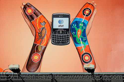 this at&t billboard advertising strangely looks like the burning man logo, aboriginal art, advertising, at&t, australian, billboard, body art, body paint, body painting, boomerangs, cell phone, gecko, hands, logo, mobile phone, wireless