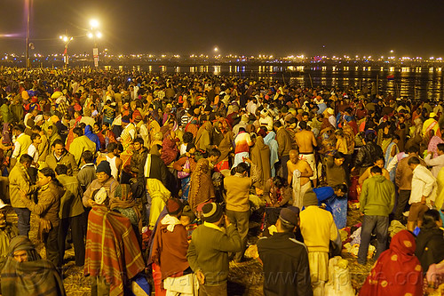 thousands of hindu pilgrims gathering for the holy bath in the ganges river at kumbh mela 2013 (india), crowd, hindu pilgrimage, hinduism, kumbh mela, men, night, paush purnima, pilgrims, street lights, triveni sangam, women