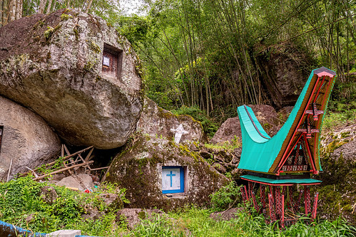 toraja rock-tombs with miniature tongkonan structure, boulder, burial site, cemetery, christian cross, graves, graveyard, liang pak, miniature tongkonan, rock tombs, tana toraja, tongkonan roof