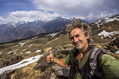 tristan savatier - hiking in the indian himalaya mountains near joshimath (india), cloudy, hiking, man, mountains, pastures, rocks, self-portrait, selfie, snow patches, thumb up, trekking, windy