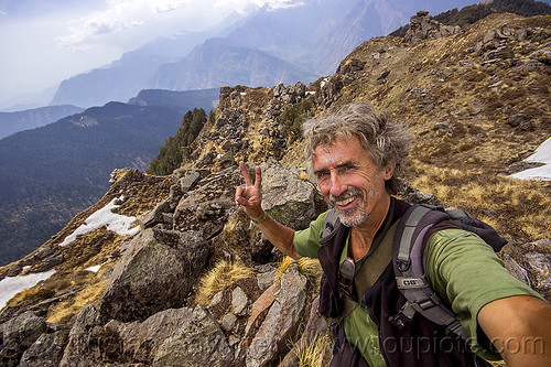 tristan savatier - selfie hiking in himalaya mountains near joshimath (india), hiking, man, mountains, peace sign, rocks, self-portrait, selfie, snow patches, trekking, v sign, victory sign