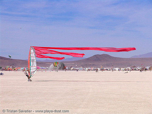 tristan windsurfing - burning man 2005, landsailing, streamer flags, streamers, street sailing, windsurfing