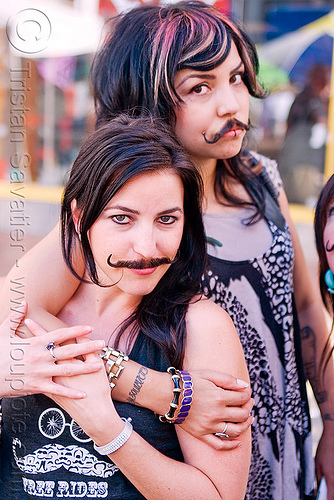 two girls with false moustaches, fake moustaches, fake mustaches, false moustaches, false mustaches, haight street fair, mustache, sarah, women