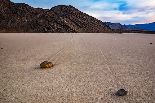 two sailing stones on the racetrack playa - death valley, cracked mud, death valley, dry lake, dry mud, landscape, mountains, racetrack playa, sailing stones, sliding rocks