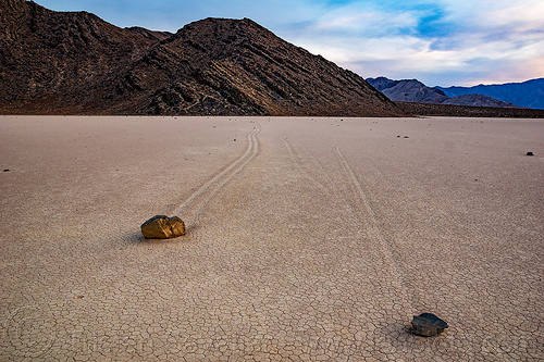 two sailing stones on the racetrack playa - death valley, cracked mud, death valley, dry lake, dry mud, landscape, mountains, racetrack playa, sailing stones, sliding rocks