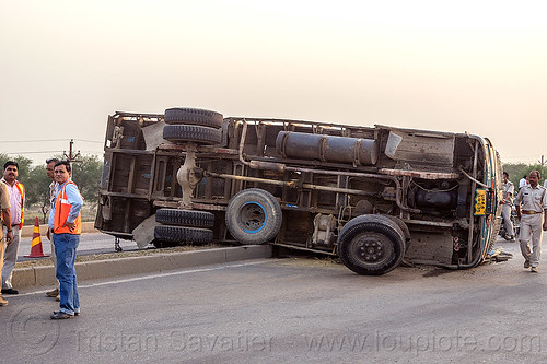 underbelly of truck overturned on median (india), crash, lorry, median, men, overturned, road, rollover, tata motors, traffic accident, truck accident, underbelly, wreck