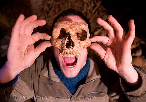 urban caver playing with a real human skull - catacombes de paris - catacombs of paris (off-limit area), cataphile, clandestines, dead, desecrated, desecration, human remains, human skull, illegal, ossuary, skeletal remains, skeleton, underground quarry