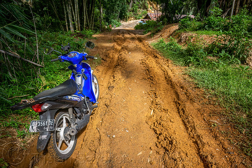 very muddy dirt road with ruts, dirt road, motorcycle, mud, muddy, ruts, tana toraja