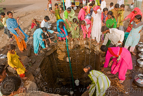 villagers around water well - ajanta (india), ajanta, buckets, communal water well, crowd, drought, pulling water, ropes, villagers, water jars, women