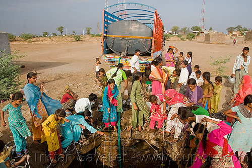 villagers pulling water from a well - ajanta (india), ajanta, communal water well, crowd, drought, pulling water, ropes, water jars, water tank, water truck, women