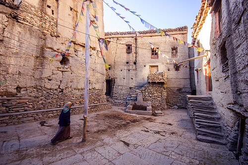 water fountain on village square - kagbeni (nepal), annapurnas, fountain, kagbeni, kali gandaki valley, pole, prayer flags, tibetan, village, woman