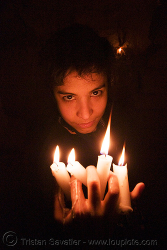 wax play - woman holding burning candles with dripping wax, candles, cataphile, cave, clandestines, fire, illegal, low key, new year's eve, underground quarry, wax play, woman
