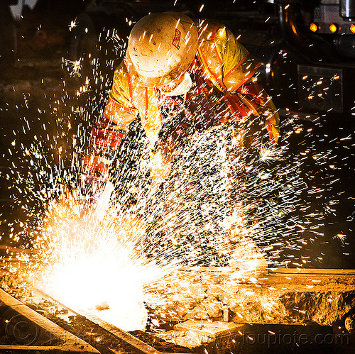 welder using oxy-acetylene cutting torch, dust mask, high-visibility jacket, high-visibility vest, light rail, man, muni, night, ntk, oxy-acetylene cutting torch, oxy-fuel cutting, railroad construction, railroad tracks, railway tracks, reflective jacket, reflective vest, safety glasses, safety helmet, safety vest, san francisco municipal railway, sparks, track maintenance, track work, welder, worker, working