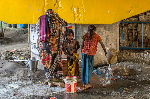 woman and girls at water hose, bridge pillar, children, daraganj, girls, hindu pilgrimage, hinduism, kids, kumbh mela, little girl, plastic bucket, plastic pipe, plastic piping, water hose, water pipe, woman