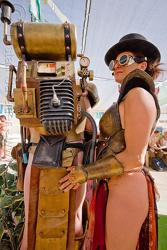 woman and golden robot, attire, burning man outfit, cuffs, gauge, goggles, hat, pipes, robot costume, spark plug, woman