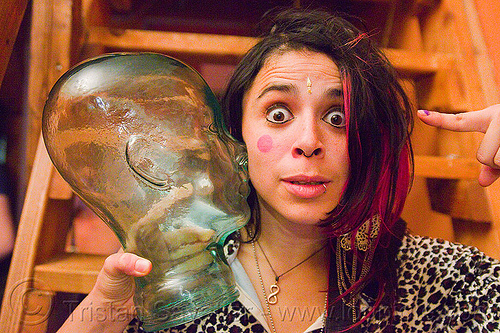 woman holding glass dummy head, glass head, woman