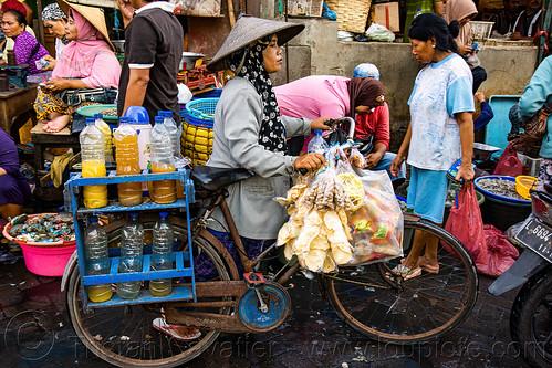 woman on bicycle selling jamy (traditional herbal medicine), fish market, seafood, street seller, surabaya