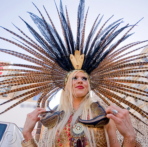 woman with feather headdress and boa snake, blonde, boa snake, costume, feather headdress, feathers, pet snake, woman