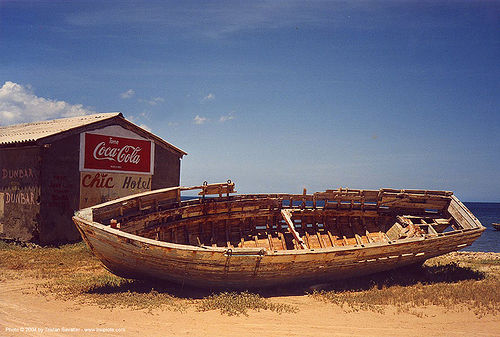 wooden boat wreck on the beach, beach, boat cemetery, boat wreck, coca cola, decaying boat, old, rotten, ship cemetery, ship graveyard, small boat, wooden boat