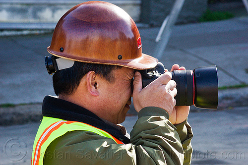 worker taking photos on construction site, camera, construction worker, duboce, high-visibility jacket, high-visibility vest, light rail, man, muni, ntk, photographer, railroad construction, railroad tracks, railway tracks, reflective jacket, reflective vest, safety helmet, safety vest, san francisco municipal railway, track maintenance, track work