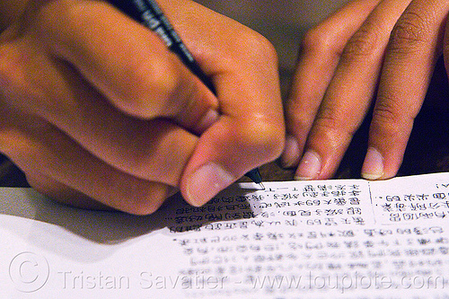 writing in chinese, borneo, chinese characters, closeup, fingers, hand writing, hands, hanzi, logographs, malaysia, paper, pen, pencil, sinographs