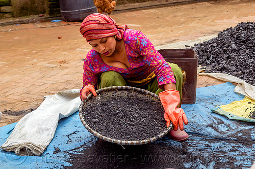 young nepali woman sifting charcoal (nepal), bhaktapur, blue, charcoal, coal, gloves, heap, sift, sifting, squatting, tarp, woman
