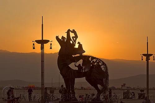 burning man - coyote sculpture, art installation, bryan tedrick, climbers, climbing, coyote sculpture, dusk, metal sculpture, statue, sunset