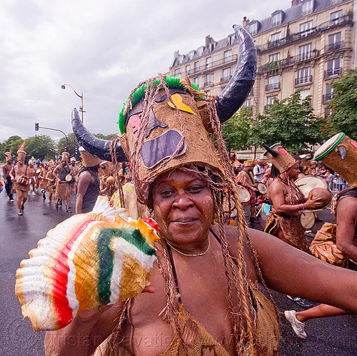 choukaj at the carnaval tropical de paris, caribbean, carnaval tropical, choukaj, conch horn, costumes, creole, créole, guadeloupe, hat, indigenous culture, parade, seashell horn, traditional, tribal, west indies, woman