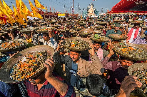clay shiva lingam's hindu offerings - kumbh mela (india), carrying on the head, clay, crowd, hindu ceremony, hindu pilgrimage, hinduism, kumbh mela, lingams, offerings, shiva linga, shiva lingam, shivling, trays, walking, yellow flags