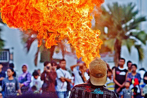 firebreather street performer (jakarta), crowd, eid ul-fitr, fatahillah square, fire breather, fire breathing, fire performer, jakarta, palm trees, spectators, spitting fire, street performers, taman fatahillah