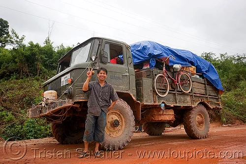 gaz-66 - газ-66 - russian all terrain 4x4 truck (laos), 4x4 trucks, all terrain, army trucks, gaz-66, lorry, man, military trucks, mud, peace sign, road, truck driver, v sign, victory sign, газ-66, го́рьковский автомоби́льный заво́д