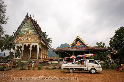 giant bamboo fireworks rocket on pickup truck - temple - vang vieng (laos), bamboo rocket, buddhism, buddhist temple, fireworks, pyrotechnics, vang vieng, wat