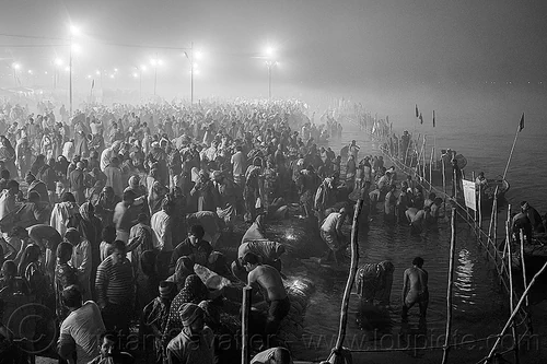 huge crowd of hindu pilgrims taking holy bath in the ganges river at night - kumbh mela (india), bathing pilgrims, crowd, fence, ganga, ganges river, hindu pilgrimage, hinduism, holy bath, holy dip, kumbh maha snan, kumbh mela, mauni amavasya, nadi bath, night, river bank, river bathing, river boats, triveni sangam