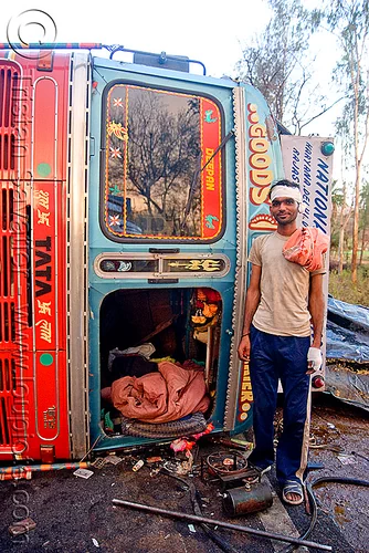 indian truck driver and his overturned truck - accident (india), cabin, crash, lorry accident, man, overturned truck, road, rollover, swastika, tata motors, traffic accident, truck accident, truck driver, trucker, wreck