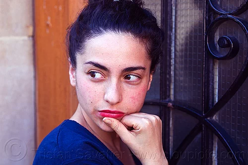 italian girl looking behind her shoulder, brunette, curly hair, dilve, hand, house door, ironwork, italian woman, long hair, red lipstick