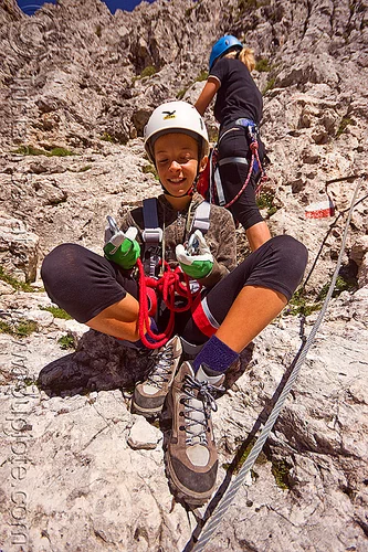 kid with climbing gear, alps, climbers, climbing harness, climbing helmet, dolomites, dolomiti, girl, hiking boots, mountain climbing, mountaineer, mountaineering, mountains, rock climbing, steel cable, teen, teenager, via ferrata