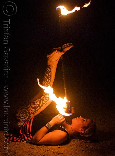 leg tattoo - lily spinning fire staff with feet (san francisco), fire dancer, fire dancing, fire performer, fire spinning, fire staff, leg tattoo, night, spinning fire, tattooed, tattoos, woman