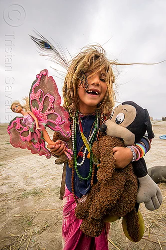 little hippie girl with pink butterfly barbie doll - ilita, baby teeth, barbie butterfly, barbie doll, blonde, child, hindu pilgrimage, hinduism, hippie, ilita, kid, kumbh mela, little girl, mickey mouse doll, missing teeth, necklaces, peacock feather, pink butterfly wings, teddybear, toys